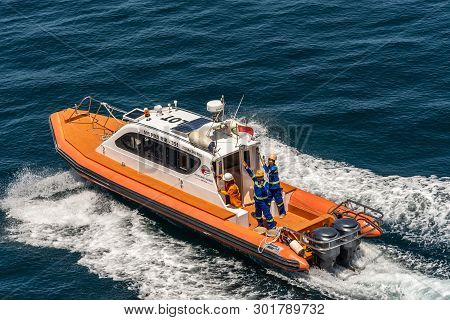 Bali, Indonesia - February 25, 2019: Outside Benoa Port. Closeup Of Orange Pilot Boat And Crew Drawi