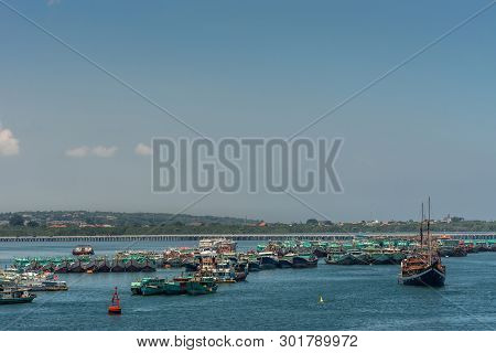 Bali, Indonesia - February 25, 2019: Pack Of Green Fishing Vessels Parked Together In The Water Righ