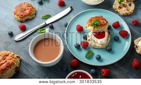 Classic Scones With Clotted Cream, Strawberries Jam, English Tea And Other Fruit