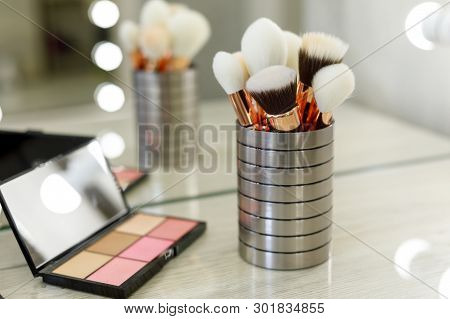 Palette With Shadows And Brushes On The Table In The Beauty Salon