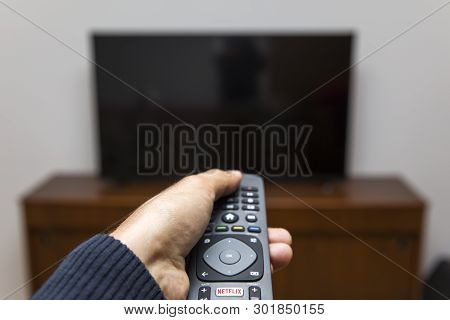Belgrade, Serbia - May 9, 2019: Hand Holding An Netflix Remote Control. Netflix Is An American Media