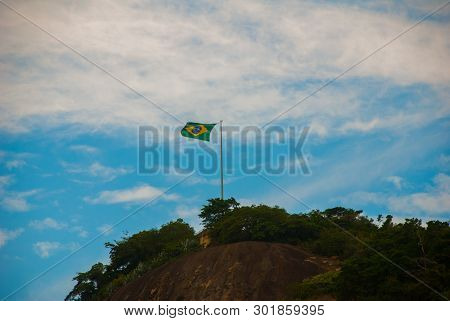 Rio De Janeiro, Lama Beach, Brazil: Beautiful Landscape With Mountain And Beach. Flag Of Brazil On T