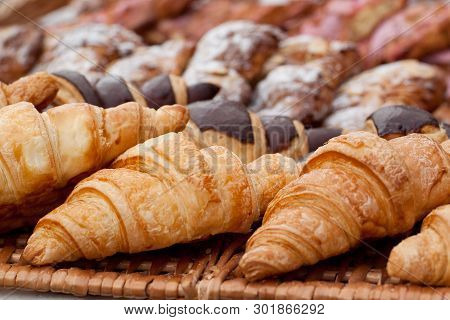 Beautiful Appetizing Croissants On A Wicker Napkin In A Cafe Or On A Storefront In A Store