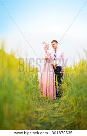 National Wedding. Bride And Groom In Field. Wedding Muslim Couple During The Marriage Ceremony. Musl
