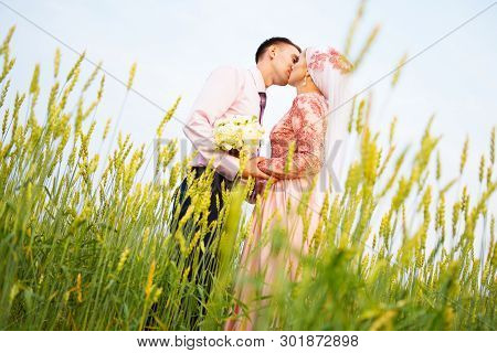 National Wedding. Bride And Groom In Field. Wedding Muslim Couple During The Marriage Ceremony. Musl