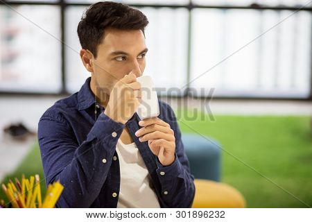 Creative Designers Man Take A Break And  Drinking Coffee From A Cup  In The  Modern Office . Busines