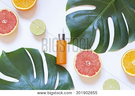 Cosmetic Flat Lay With Vitamin C Serum And Citrus On The White Background. Top View