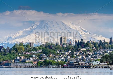 Mount Rainers Seems To Be Right On Top Of A Neighborhood In Tacoma, Washington.
