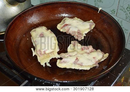 Fried Meat In A Pan With Breading