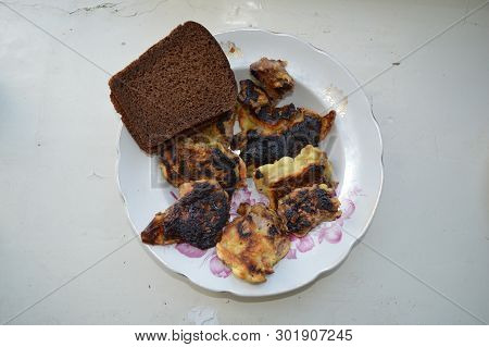 Fried Meat In A Pan With Breading