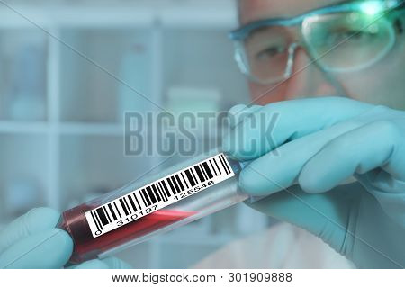 Tech With A Medical Sample Labeled With A Barcode