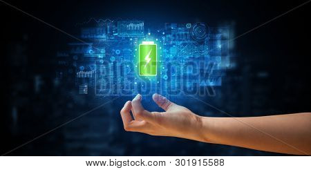Elegant hand holding battery with full of energy