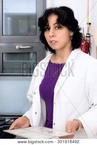 Senior Female Scientist With Histological Samples Indoors