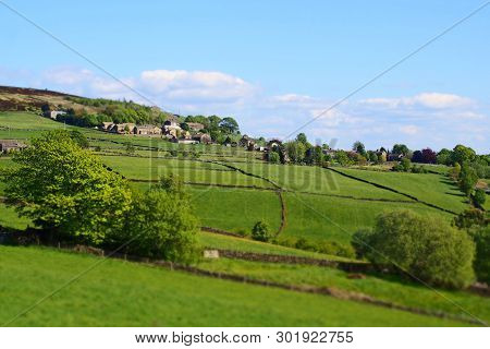 A Selective Focus View Of The Village Of Midgley In West Yorkshire With Surrounding Green Fields And