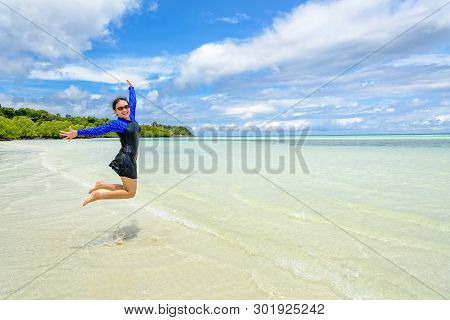 Happy Asian Teen Girl Wearing A Swimsuit Jumping Fun On The Beach Of Ko Ra Wi Under The Blue Sky Dur