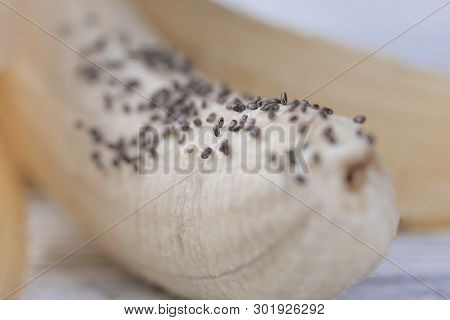 Ripe Banana With Chia Seeds On A Wooden Background