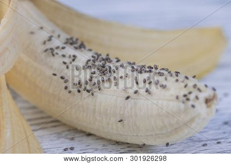 A Half-peeled Banana With Chia Seeds Poured On It