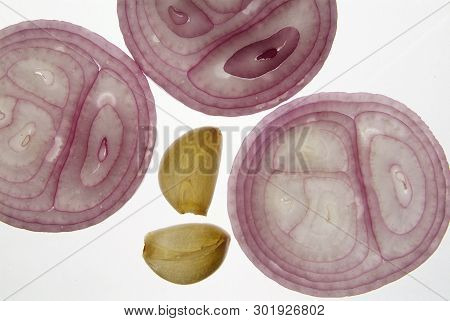 Cross Section Slice Of Red Onion And Garlic Against Light Background On Backligts