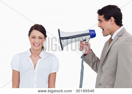 Salesman yelling at colleague with megaphone against a white background