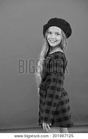 Kid Little Cute Girl With Long Hair Posing In Hat Red Background. How To Wear French Beret. Beret St