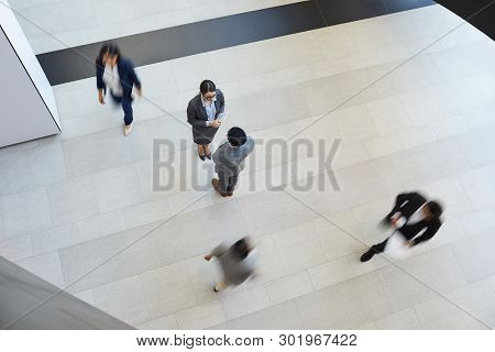 Directly Above View Of Young Multi-ethnic Business Partners In Formal Outfits Standing On Tile Floor