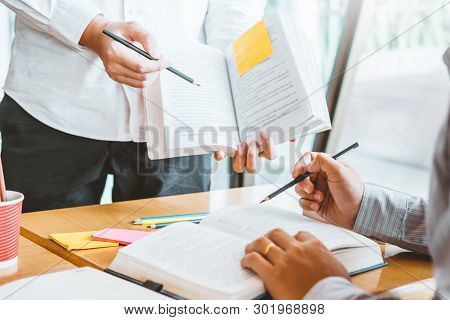 High School Or College Students Studying And Reading Together In Library