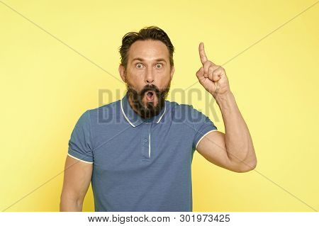 Surprised Man With Open Mouth Keep Finger Pointing Up. Beraded Man Surprised With Epiphany And Sudde