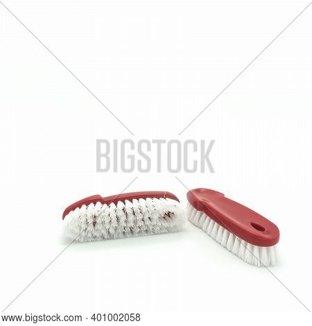 Two Brushes For Cleaning The House. Red Plastic Curly Base. Long White Bristles. Isolated Over White
