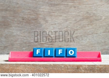 Tile Letter On Red Rack In Word Fifo (abbreviation Of First In First Out) On Wood Background