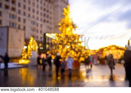 Christmas Holiday Background. Christmas Tree In Shining Garland At New Years Outdoor Marketplace Fai