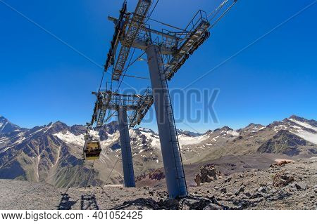 Cable Car Cabin Over A Precipice In The Mountains. Travel By Cable Car In The Caucasus Mountains To 