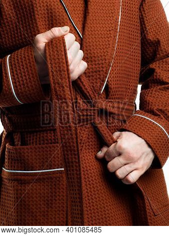 Man In A Bright, Bath Robe Advertises Clothing Details On An Isolated White Background.