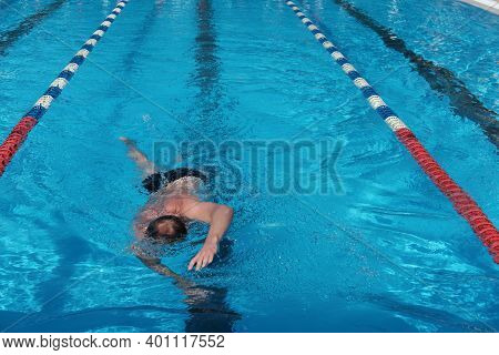 Middle Age Man Swimming In Open Air Pool. Active Lifestyle And Leisure. Sporty Man Enjoing Swimming.