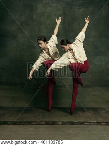 Line. Two Young Female Ballet Dancers Like Duelists With Swords On Dark Green Background. Caucasian 