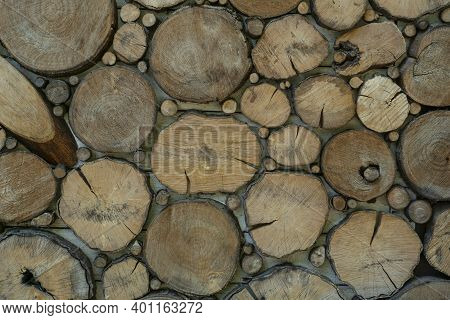 Wooden Background Made Of Cutted Round Wood Secrions Different Sizes And Shapes. Natural Materials. 