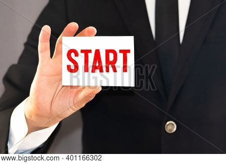 Man Showing White Card With Start Word . Business Concept