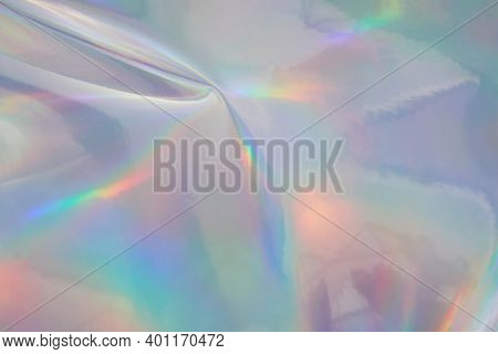 Rainbow Halographic Wrinkled Foil Background. Abstract Pastel Color Background.
