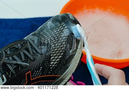 Washing The Dirty Sneakers. Cleaning Running Shoe Outsoles.