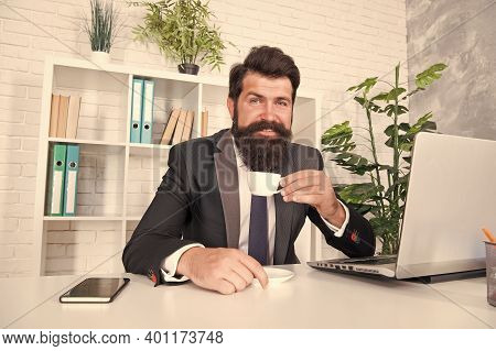 Man Handsome Boss Sit In Office Drinking Coffee. Comfy Workspace. Bearded Hipster Formal Suit Relaxi