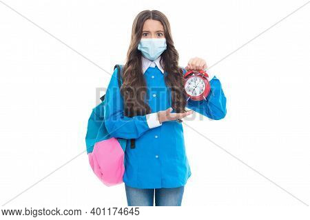 Stressed School Child In Medical Face Mask Hold Alarm Clock Being Anxious About No Specific Coronavi