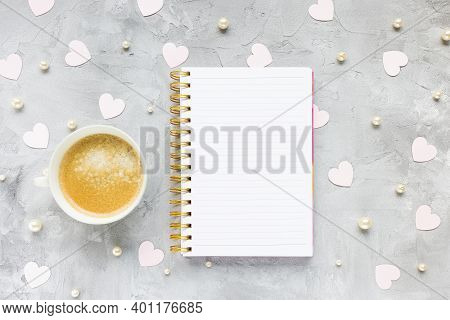 Notepad, Cup Of Coffee, Pearls And Pink Paper Hearts On Woman Desk Workspace, Gray Background. Vanet