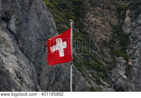 Swiss Flag Waving In The Wind In Alpstein Mountains Alpine Rocky Background Appenzell In Switzerland