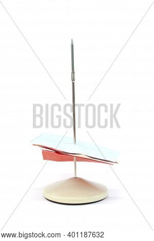 A Spindle Bill Holder With Notepaper Isolated On White Background.