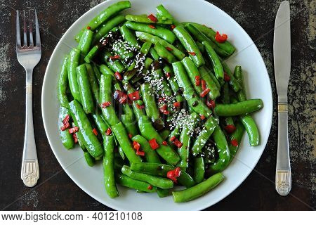 Green Pea Pods With Chilli And Sesame. Green Pods In Chinese Style.