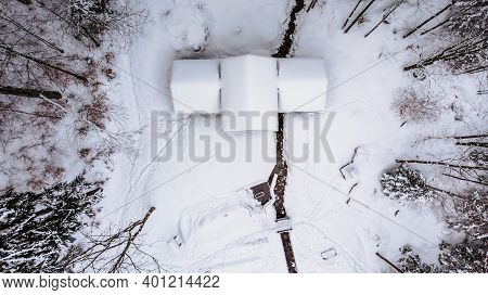 Aerial View Of Rural House Covered With Snow. Winter Icy Landscape, Fresh Stream,trees From Above.wi