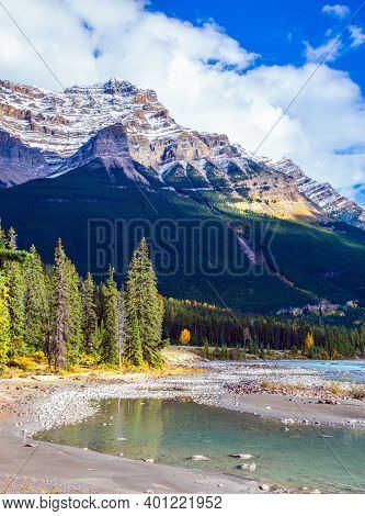 Mountains, rivers and waterfalls make up magnificent landscapes. Canada. The Athabasca River begins at the Columbia Glacier in Jasper Park. Travel, ecological and photo tourism concept