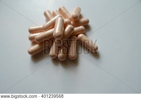 Handful Of Pink Capsules Of Probiotic Dietary Supplement