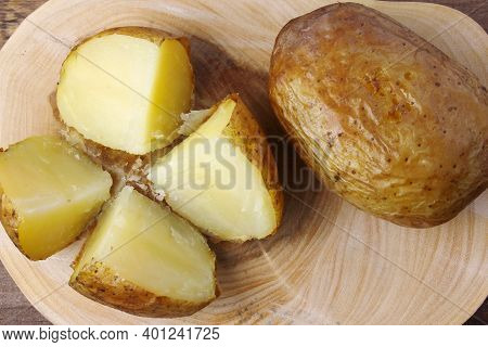 Hot Baked Potato On Rustic Wooden Table. Top View