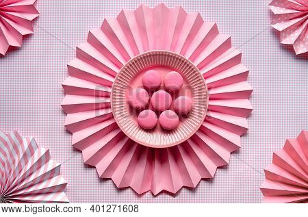 Sweet And Tasty Macaroons On A Plate. Creative Monochrome Flat Lay On Checkered Pink Paper And Folde