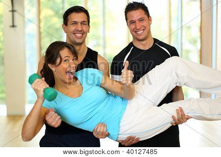 Gruppe, die mit Hanteln im Fitnessstudio